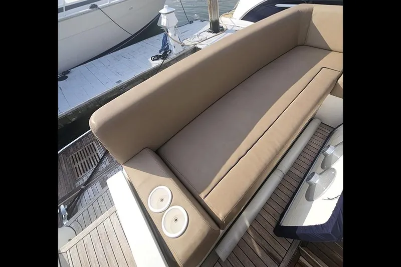 Slide: The Image of 2015 Fairline Targa 48 GT yacht with tan seating and wooden deck. - 15