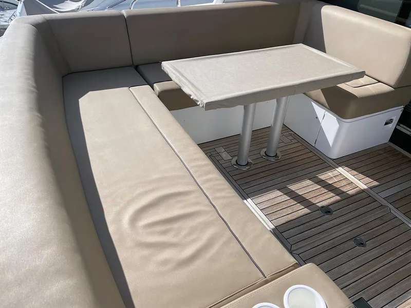 Slide: The Image of 2015 Fairline Targa 48 GT yacht interior with beige seating and wooden flooring. - 17