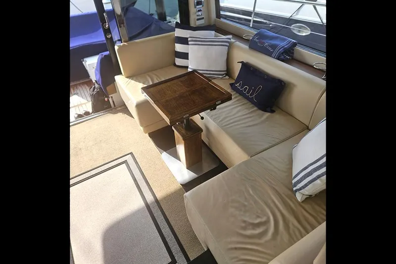 Slide: The Image of Interior of 2015 Fairline Targa 48 GT yacht with beige seating and decorative pillows. - 19