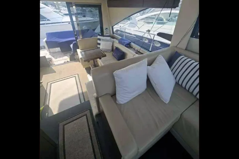 Slide: The Image of Interior of 2015 Fairline Targa 48 GT yacht with beige seating and striped cushions. - 22