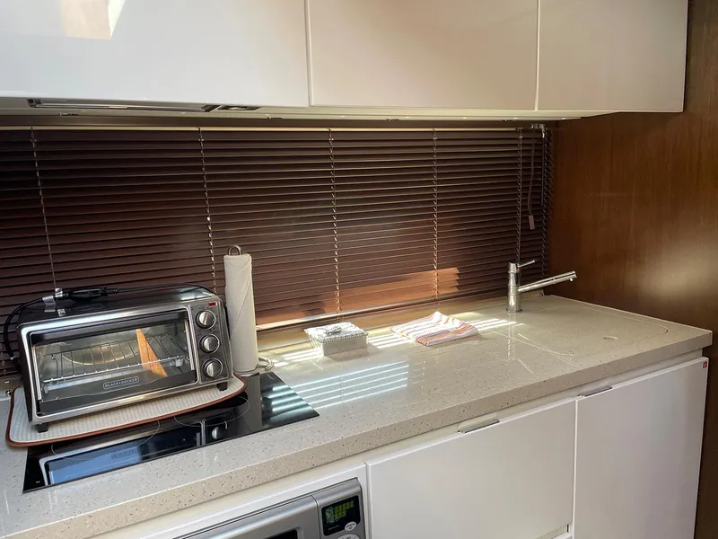 Slide: The Image of Modern kitchen area in a 2015 Fairline Targa 48 GT yacht with appliances and sleek design. - 23