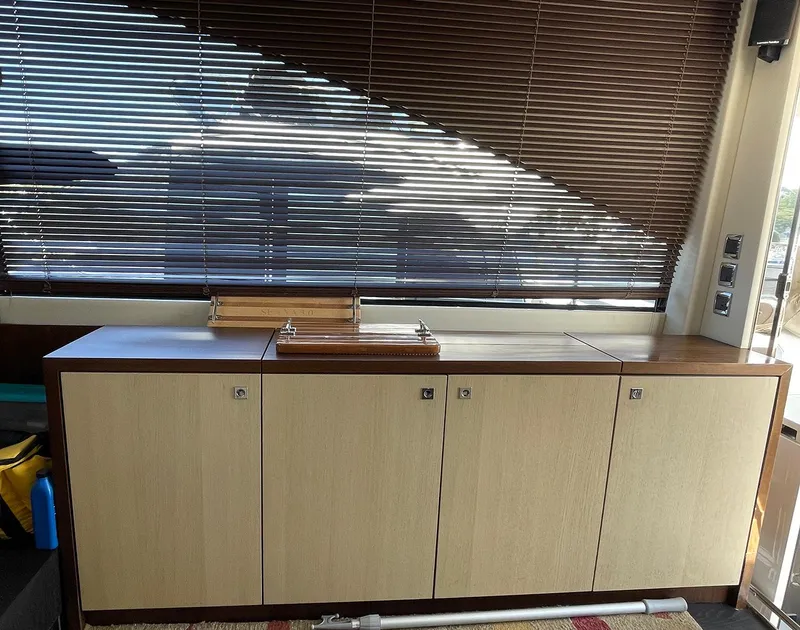 Slide: The Image of Interior of 2015 Fairline Targa 48 GT with wooden cabinets and blinds. - 7