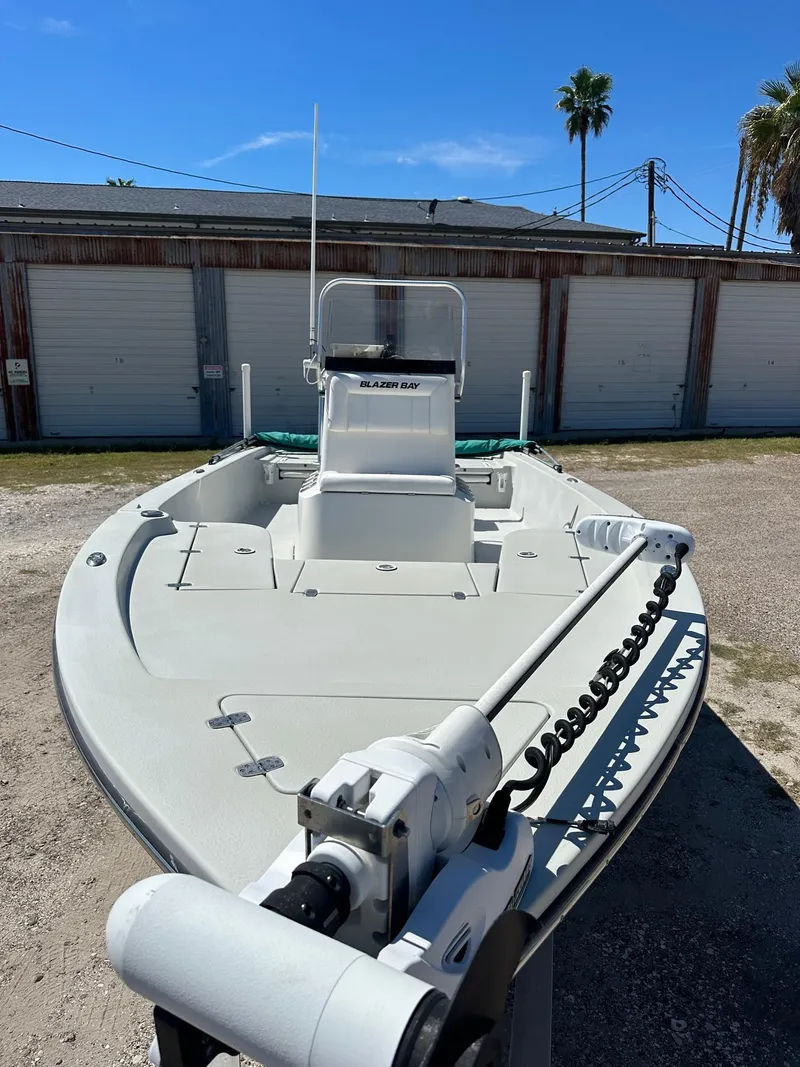 Slide: The Image of 2015 Blazer 2220 boat with trolling motor in front of storage units. - 3