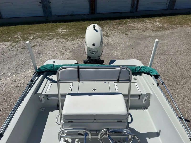 Slide: The Image of 2015 Blazer 2220 boat with white seating and outboard motor. - 6