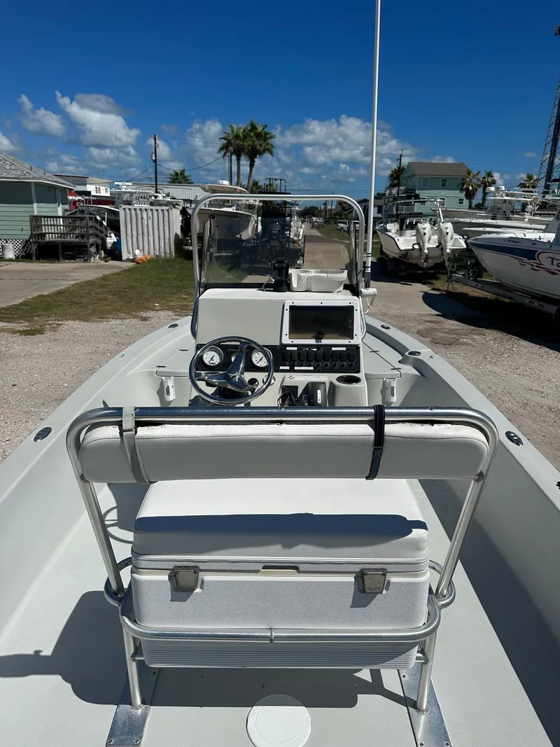 Slide: The Image of 2015 Blazer 2220 boat with center console and seating, docked at a marina. - 9
