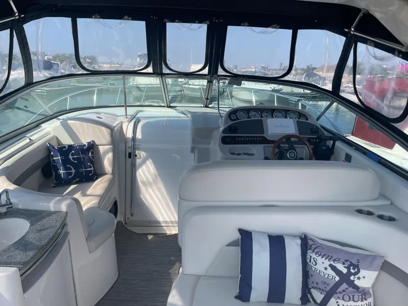 Slide: The Image of 2007 Chaparral 330 Signature boat interior with helm, seating, and nautical-themed pillows. - 11