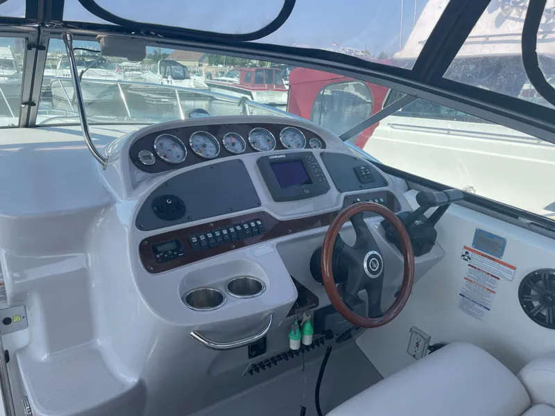 Slide: The Image of 2007 Chaparral 330 Signature boat helm with gauges, steering wheel, and controls. - 14