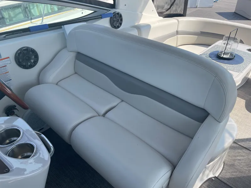 Slide: The Image of 2007 Chaparral 330 Signature boat interior with white leather seating and cup holders. - 15