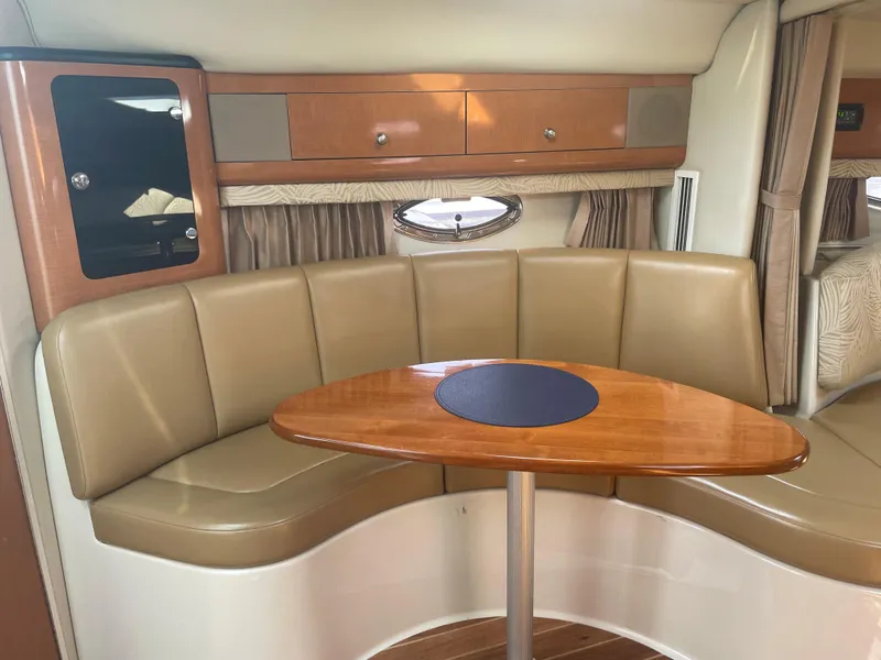 Slide: The Image of 2007 Chaparral 330 Signature yacht interior with leather seating and wooden table. - 31