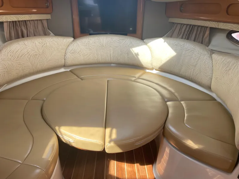 Slide: The Image of 2007 Chaparral 330 Signature boat interior with circular seating and wooden flooring. - 34