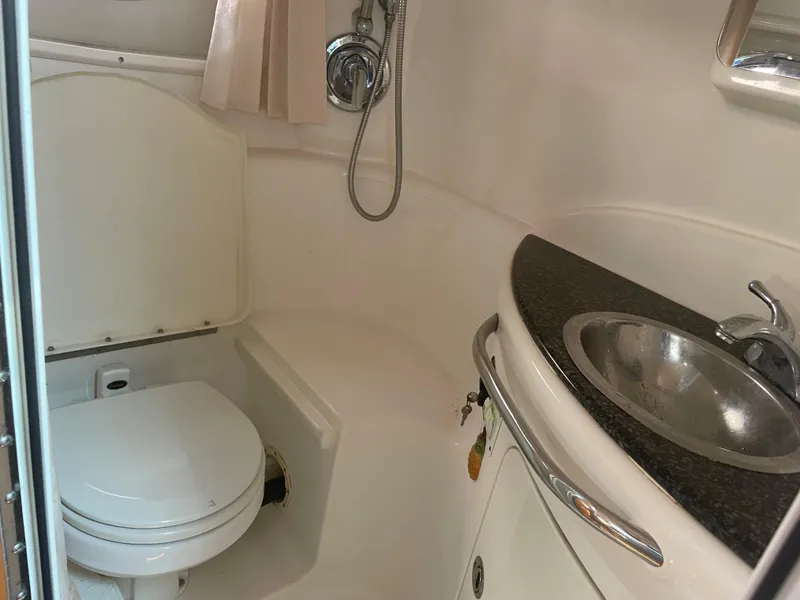 Slide: The Image of 2007 Chaparral 330 Signature boat bathroom with toilet, sink, and shower. - 40