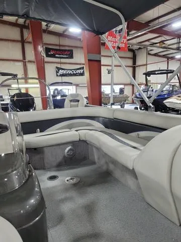 Slide: The Image of 2023 Lowe SD 224 boat interior with seating, displayed in a showroom. - 12