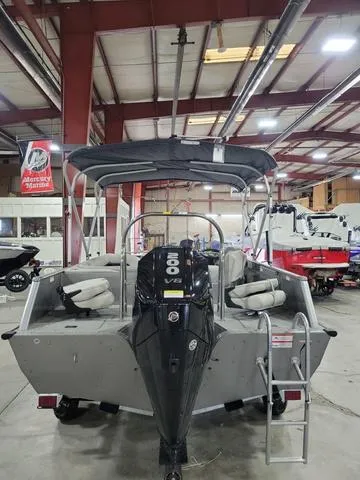 Slide: The Image of 2023 Lowe SD 224 pontoon boat with 200 HP engine in showroom. - 3