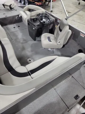 Slide: The Image of 2023 Lowe SD 224 boat interior with steering console and seating. - 5