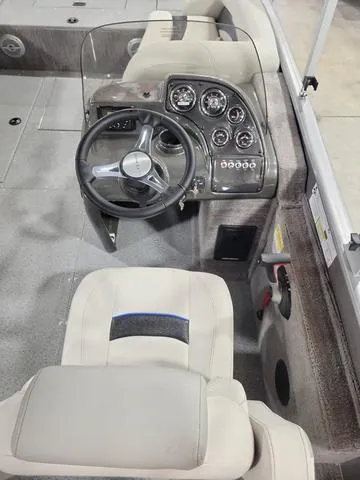 Slide: The Image of 2023 Lowe SD 224 boat dashboard and captain's chair, featuring modern controls and comfortable seating. - 6
