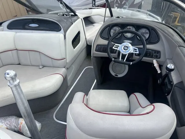 Slide: The Image of 2005 Malibu Sunsetter LXi boat interior with steering wheel and seating. - 8