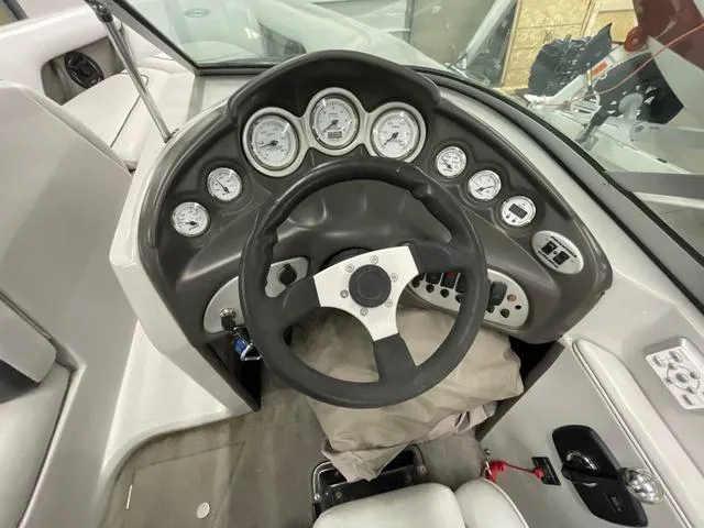 Slide: The Image of 2006 Moomba Outback boat dashboard with steering wheel and gauges. - 11