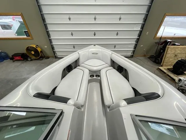 Slide: The Image of 2006 Moomba Outback boat interior with white seating in a garage setting. - 12