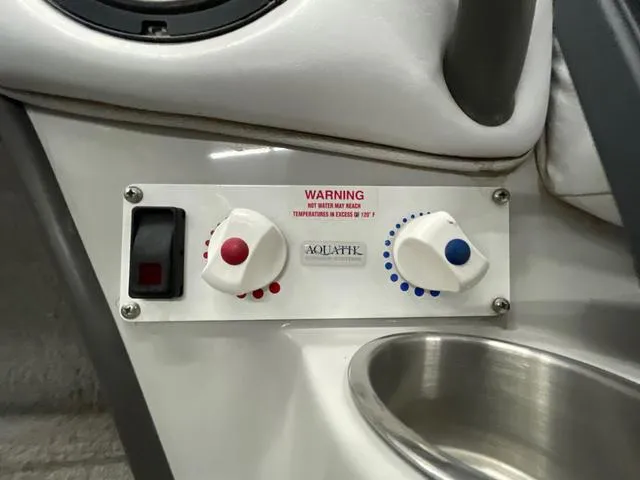 Slide: The Image of Control panel in a 2006 Moomba Outback boat with temperature warning and adjustment knobs. - 15