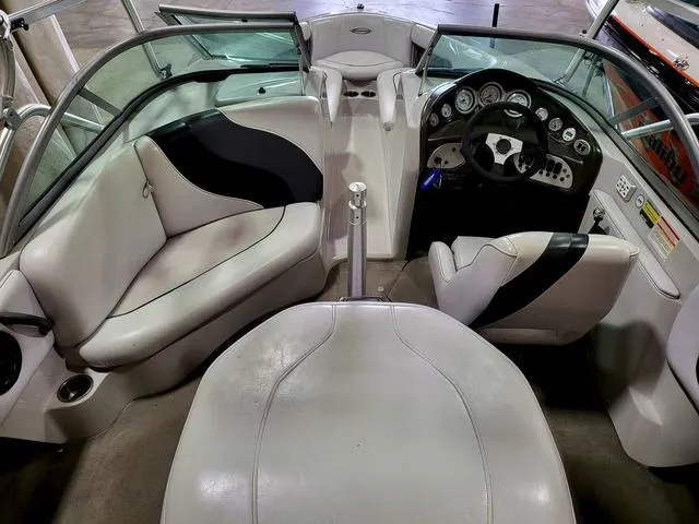 Slide: The Image of 2006 Moomba Outback boat interior with white and black seating, dashboard, and steering wheel. - 6