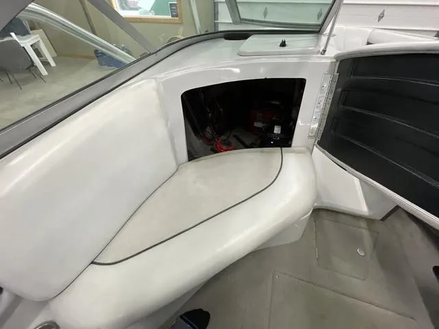 Slide: The Image of 2006 Moomba Outback boat interior with open storage compartment and white seating. - 9