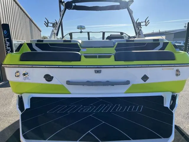 Slide: The Image of 2024 Malibu 22 LSV boat, rear view, green and white color scheme. - 10