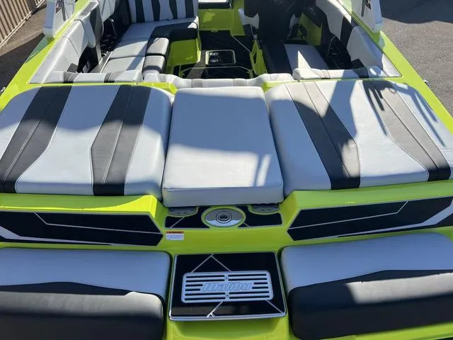 Slide: The Image of 2024 Malibu 22 LSV boat interior with lime green and black seating. - 3