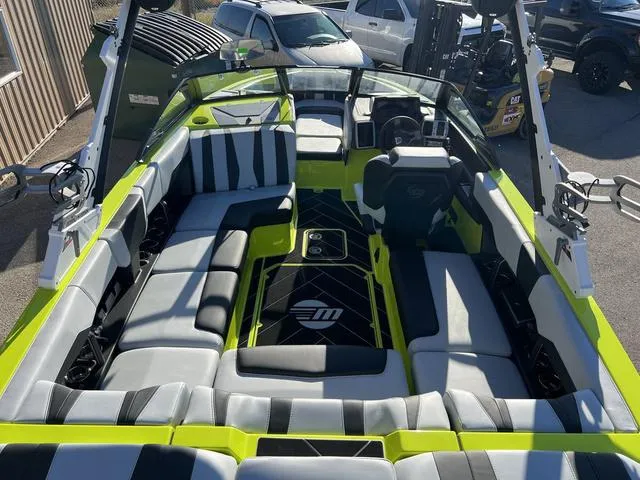 Slide: The Image of 2024 Malibu 22 LSV boat interior with lime green and black seating. - 7