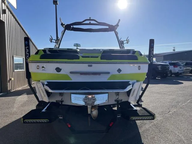 Slide: The Image of 2024 Malibu 22 LSV boat rear view in a parking lot under bright sunlight. - 9