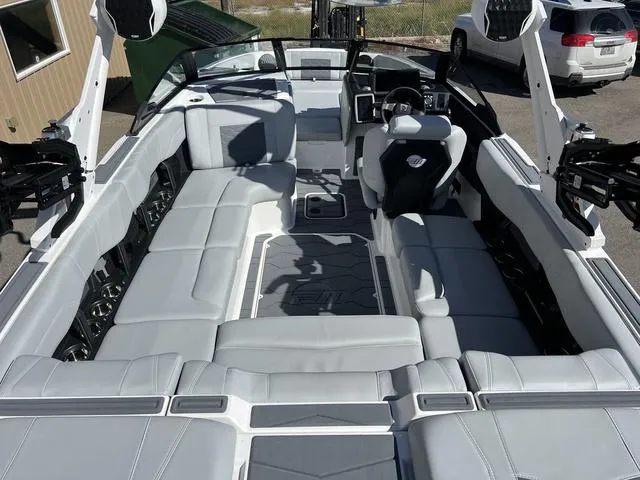 Slide: The Image of 2024 Malibu 23 MXZ boat interior with spacious seating and modern design. - 12