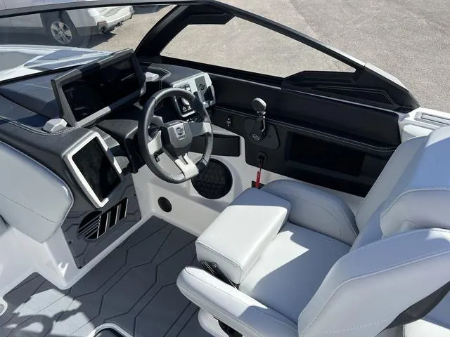 Slide: The Image of 2024 Malibu 23 MXZ boat interior with modern dashboard and steering wheel. - 13