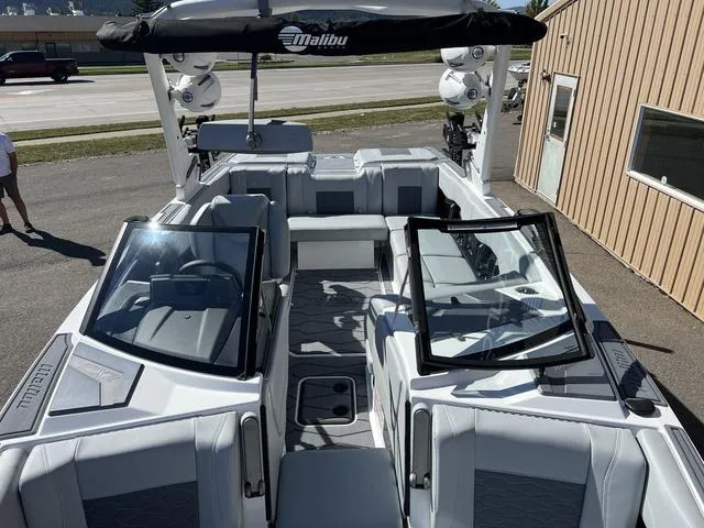 Slide: The Image of 2024 Malibu 23 MXZ boat interior with open bow and seating. - 14