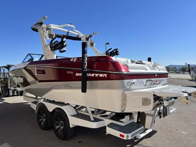 Slide: The Image of 2024 Malibu 23 MXZ wakeboard boat on a trailer, rear view. - 6