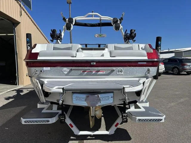 Slide: The Image of 2024 Malibu 23 MXZ boat rear view with swim platform and wakeboard tower. - 7