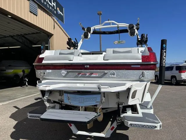 Slide: The Image of 2024 Malibu 23 MXZ boat rear view at dealership. - 8
