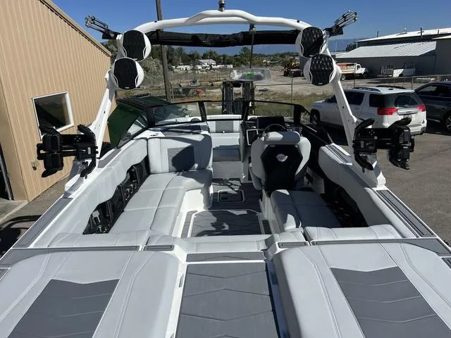 Slide: The Image of 2024 Malibu 23 MXZ boat interior with spacious seating and advanced audio system. - 9