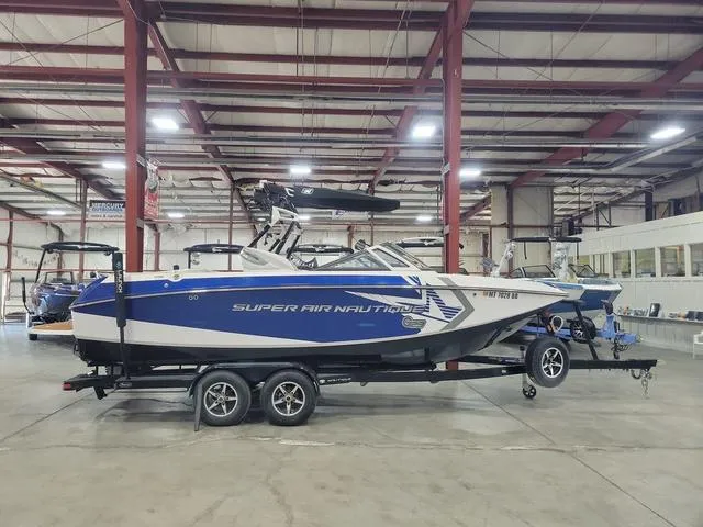 Slide: The Image of 2015 Nautique G23 Super Air boat in indoor storage facility. - 1