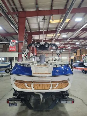Slide: The Image of 2015 Nautique G23 boat in indoor showroom, rear view. - 4