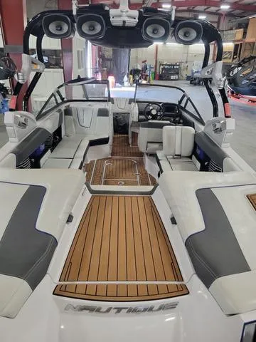 Slide: The Image of 2015 Nautique G23 boat interior with teak flooring and premium seating. - 6