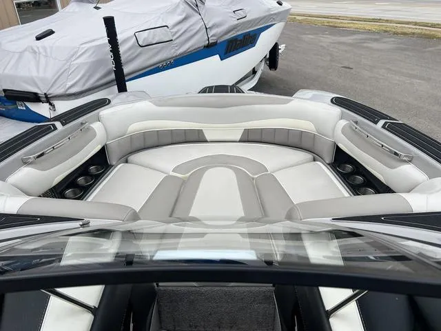 Slide: The Image of 2013 Malibu Wakesetter 22 MXZ boat interior with plush seating and cup holders. - 12