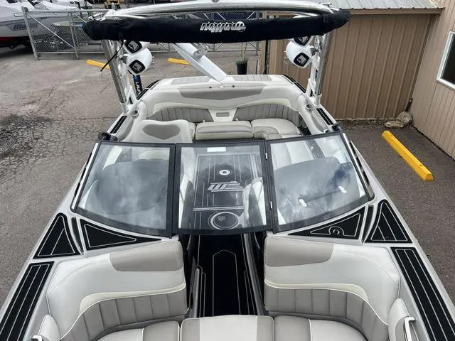 Slide: The Image of 2013 Malibu Wakesetter 22 MXZ boat interior with seating and windshield. - 6