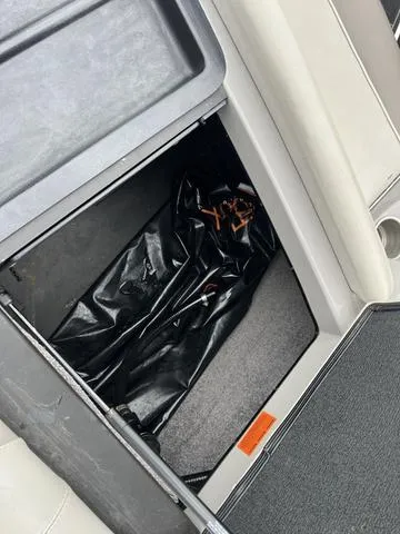 Slide: The Image of 2013 Malibu Wakesetter 22 MXZ storage compartment with black bag. - 7