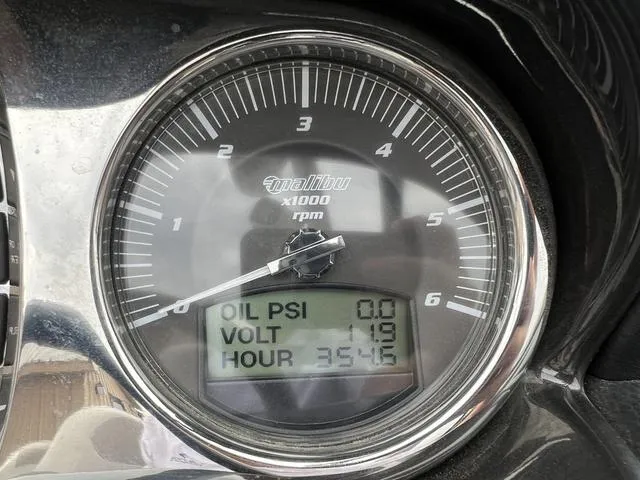 Slide: The Image of Close-up of 2013 Malibu Wakesetter 22 MXZ boat gauge showing oil PSI, voltage, and hours. - 8
