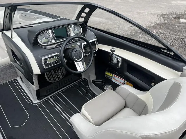 Slide: The Image of 2013 Malibu Wakesetter 22 MXZ boat interior, featuring a modern dashboard and steering wheel. - 9
