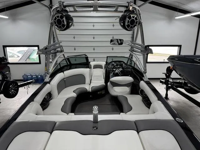 Slide: The Image of 2007 Supra Boats 21V LTD interior with sleek seating and advanced audio system in a garage. - 12
