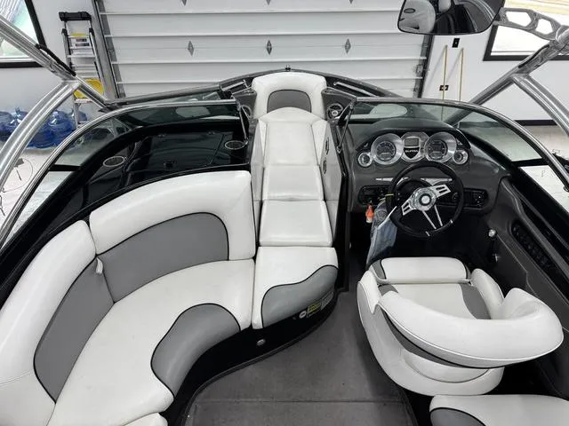 Slide: The Image of 2007 Supra Boats 21V LTD interior with white and gray seating, sleek dashboard, and steering wheel. - 13