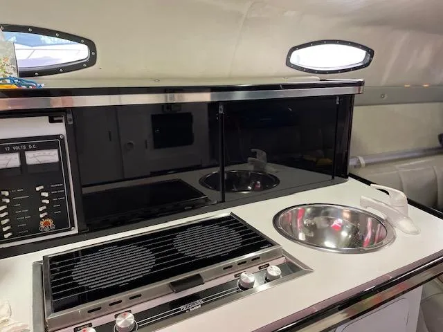 Slide: The Image of 1989 Baja 370 Force boat interior kitchen with stove, sink, and storage. - 10