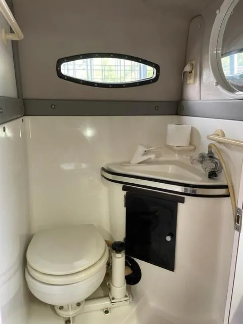 Slide: The Image of Compact bathroom in a 1989 Baja 370 Force boat with toilet and sink. - 12