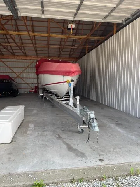 Slide: The Image of 1989 Baja 370 Force boat on trailer in a storage shed. - 15