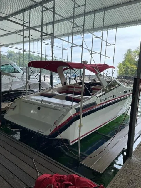 Slide: The Image of 1989 Baja 370 Force boat docked under a covered marina. - 3